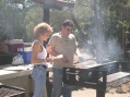 Alex tends the grill while Patti supervises